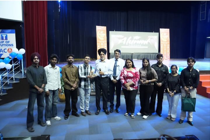 Group photo on stage at an alumni event